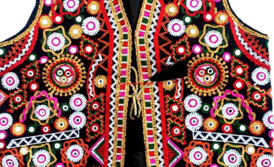 A traditional embroidered vest with intricate mirror work and colorful patterns, featuring cultural craftsmanship